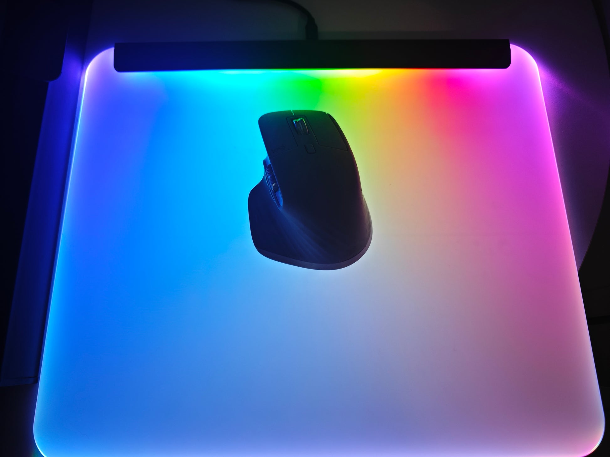 Gaming setup with illuminated mouse mat displaying screen sync mode